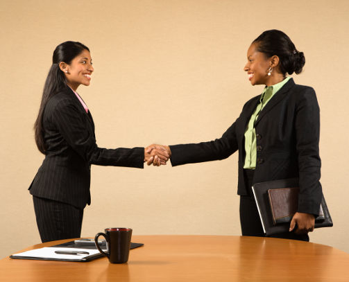 businesswomen shaking hands