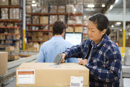 woman with barcode reader in warehouse